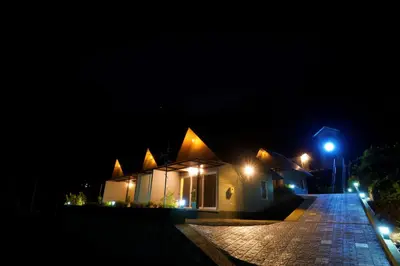 a house at night with lights on the street at Elephant Village Private Pool Villa in Munnar
