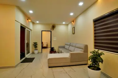 a living room with a couch and some plants at Elephant Village Private Pool Villa in Munnar