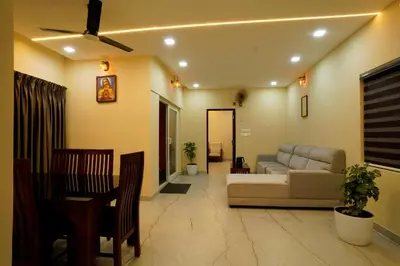 a living room with a couch and a table at Elephant Village Private Pool Villa in Munnar