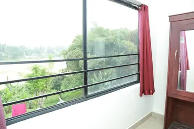 a window with a view of the forest at Royal Park in Wayanad
