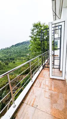 an open door on a balcony with a view at VALLEY VIEW INN, Kotagiri in Kotagiri