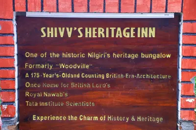 a sign on the side of a brick building at Shivvs Heritage Resort Ooty in Ooty