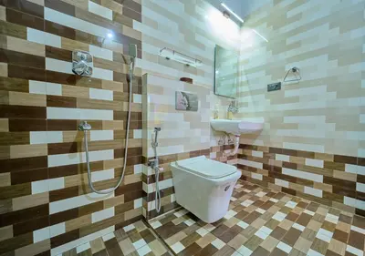 a bathroom with a shower and a toilet and a sink at EMYs Misty Charm Private Villa Ooty by VOYE HOMES in Ooty