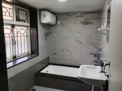a bathroom with a bath tub and a sink and a window at The silver dale homestay 1 in Ooty