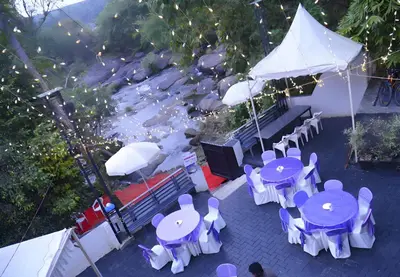 an overhead view of tables and chairs with umbrellas at Palatty's Resorts in Athirappally