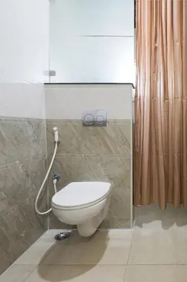 a bathroom with a toilet and a shower at Ananyas Nest in Coimbatore