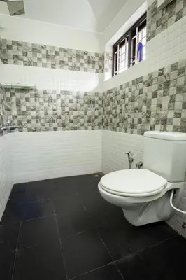 a bathroom with a toilet and a bath tub at Haven inn in Kotagiri
