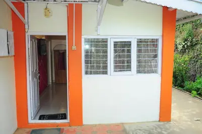 an orange and white door of a house at Bethany stay in Ooty