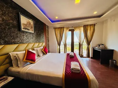 a bedroom with a large bed with a large window at Sunrise Peak View in Lovedale