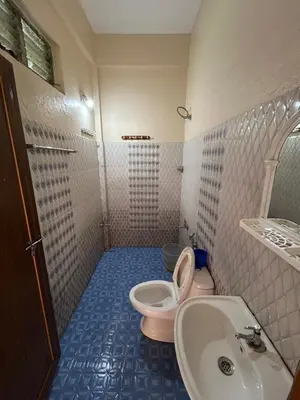 a bathroom with a toilet and a sink at GV Royal Residency Vattavada in Vattavada
