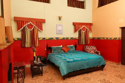 a bedroom with a bed in a red room at Cliff Club Resort Ooty in Ooty