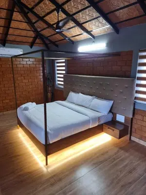 a bedroom with a bed in a room with lights at KK Selfie Point Resort in Coimbatore