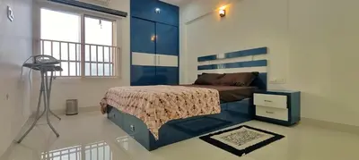 a bedroom with a bed and a blue and white wall at 3 Bedroom River view apartment in Aluva, near Cochin Airport in Alwaye