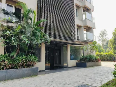 an external view of a building with a courtyard at 3 Bedroom River view apartment in Aluva, near Cochin Airport in Alwaye