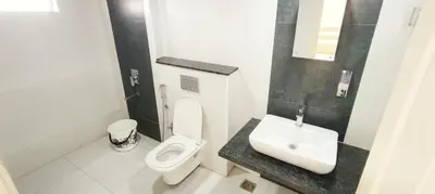 a bathroom with a toilet and a sink at 3 Bedroom River view apartment in Aluva, near Cochin Airport in Alwaye