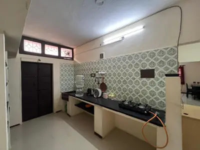 a room with a counter and a window in a room at SHI's 2bhk Near Ganga Hospital in Coimbatore