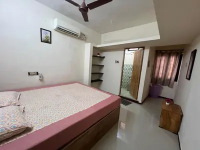 a bedroom with a bed in a room with a window at SHI's 2bhk Near Ganga Hospital in Coimbatore