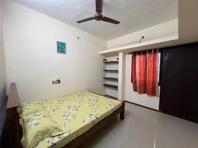 a bedroom with a bed and a ceiling fan at SHI's 2bhk Near Ganga Hospital in Coimbatore