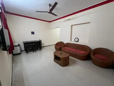 a living room with a couch and a table at SHI's 2bhk Near Ganga Hospital in Coimbatore
