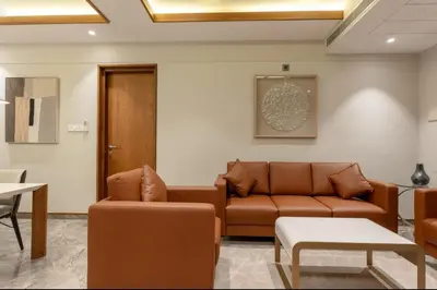 a living room with a couch and a table at Seashell Apartments in Kozhikode