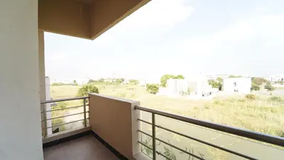 a balcony with a view of a field at Codissia In Nini Residency in Coimbatore