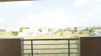 a balcony with a view of a city at Codissia In Nini Residency in Coimbatore