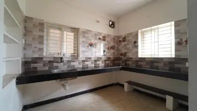 a bathroom with a sink and two windows at Codissia In Nini Residency in Coimbatore