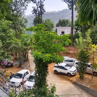 a group of cars parked in a parking lot at Holy Village Homestay in Neriyamangalam