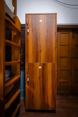a wooden cabinet in a room with wooden shelves at Leo Vishroam in Mysore