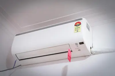 a white microwave oven with a pink sticker on it at Leo Vishroam in Mysore