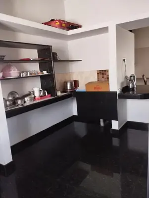 a kitchen with a counter with pots and pans at NJM Villa in Coimbatore