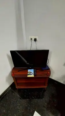 a wooden table with a laptop on top of it at NJM Villa in Coimbatore