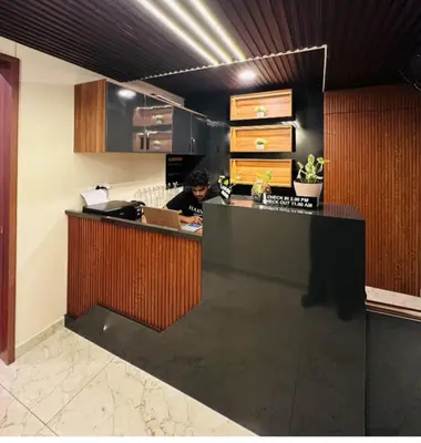 a person sitting at a counter in an office at Sara Archid in Kommeri
