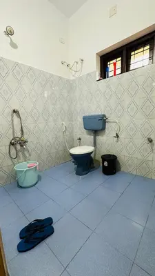 a bathroom with a toilet and a sink at Golden pearl private villa with pool in Vythiri