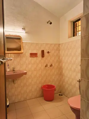 a bathroom with a toilet and a sink at Boughn Villa in Kozhikode