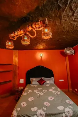 a bedroom with a bed with flowers on it at Beehive staycations in Ambalavayal