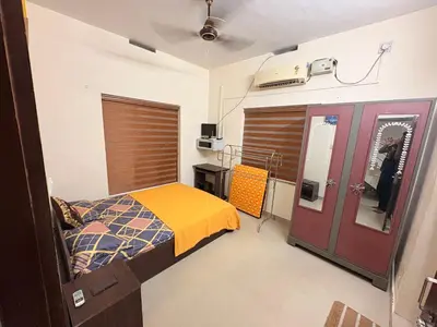 a hospital room with a bed and a window at Moms Villa in Nedumbassery