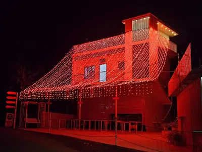 a red building with lights on it at night at Mariya Home Stay in Kanjikode