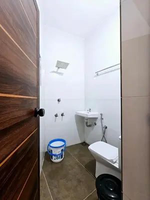 a bathroom with a toilet and a sink at Mariya Home Stay in Kanjikode