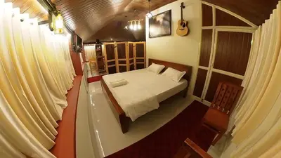 a small room with a bed and a window at Homestay Rooms Muzhakkunnu Near Kannur International Airport in Iritti