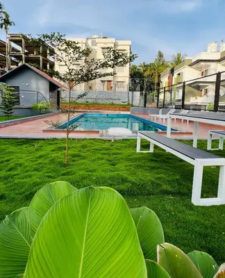 a park with a bench and a swimming pool at Wild Wind Resort in Batheri