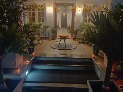 a hallway with potted plants and a table in the middle at The Elegant homes in Kushālnagar