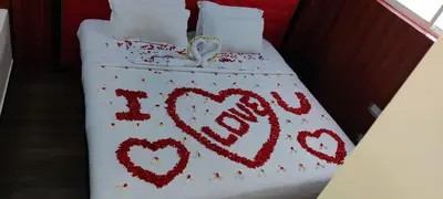 a bed with two hearts painted on it at Ghala Residency in Munnar