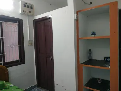 a room with a wooden door and a shelf at Mithu's Nest-Ur Holiday Abode in Coimbatore
