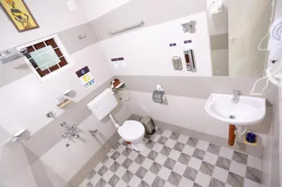 a bathroom with a toilet and a sink at Base9 Family Lounge -Cochin Airport in Nedumbassery