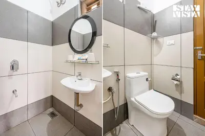 a bathroom with a toilet and a sink and a mirror at Stayvista at Whitewood Serene 5BHK Homestay - Wayanad in Wayanad