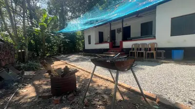 a house with a blue tarp over it at Tharavadu Homestay in Athirappilly