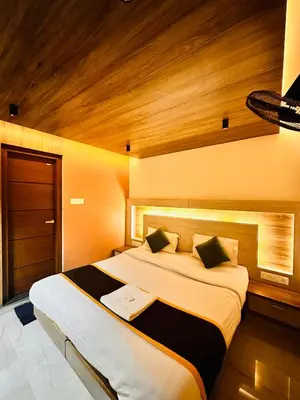 a bedroom with a large bed in a room at City Palace Hotel in Ooty