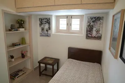 a small bedroom with a bed and a window at Perfect getaway in Mysore