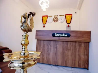 a table with a gold bird on top of a trophy at Hotel Diamond Castle in Manjeri